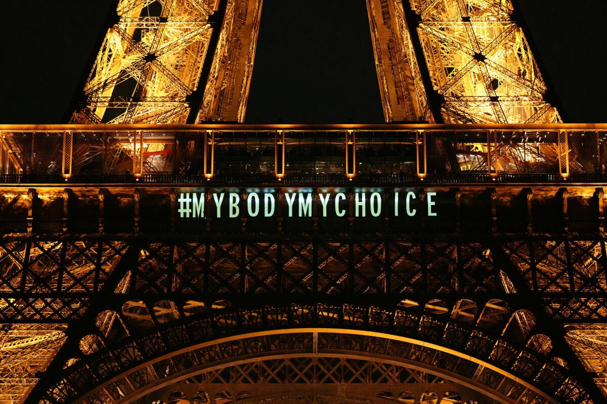 A message reading "My body my choice" projected onto the Eiffel Tower