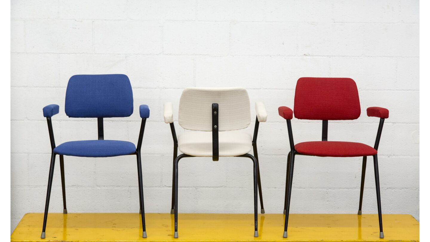 Stacking upholstered industrial arm chairs by Cox / England. Tubular stacking chairs with upholstere