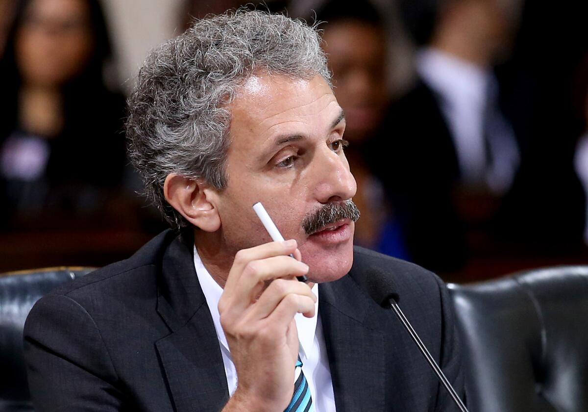 Los Angeles City Atty. Mike Feuer, shown at a City Council meeting in March, announced 30-day tobacco sale suspensions against businesses that sold such products to minors.