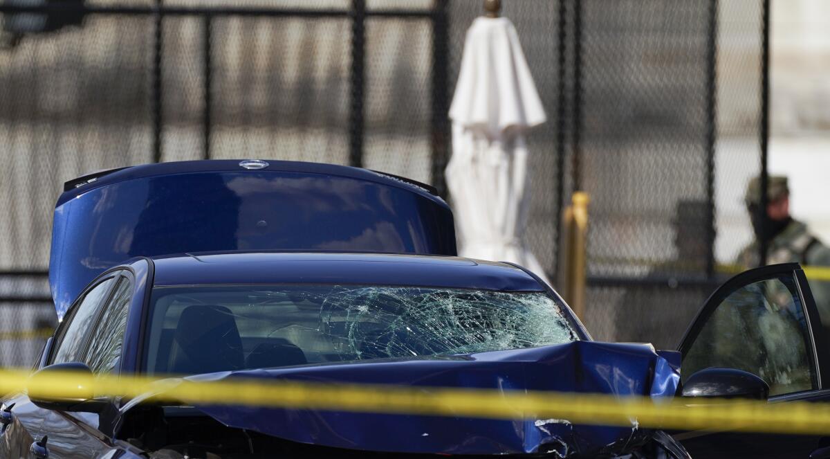 A car with a smashed windshield on Capitol Hill.