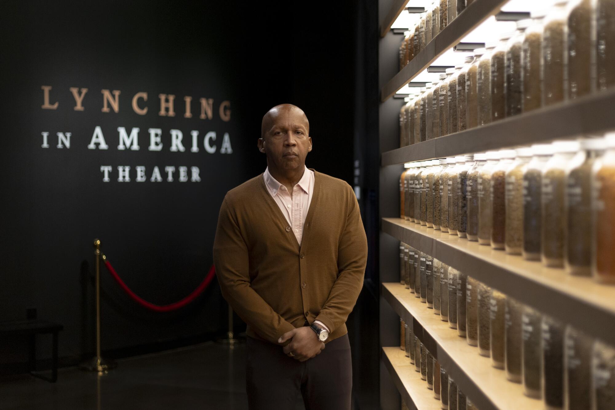 Bryan Stevenson stands in front of a collection of soil from lynching sites at the Legacy Museum.