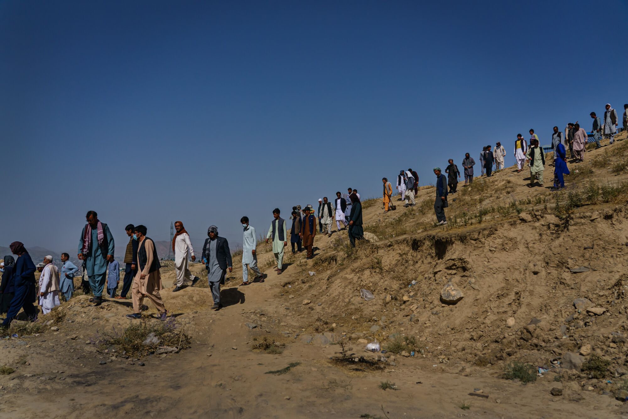 Relatives walk down Martyrs Hill after a funeral for Mushtaq.