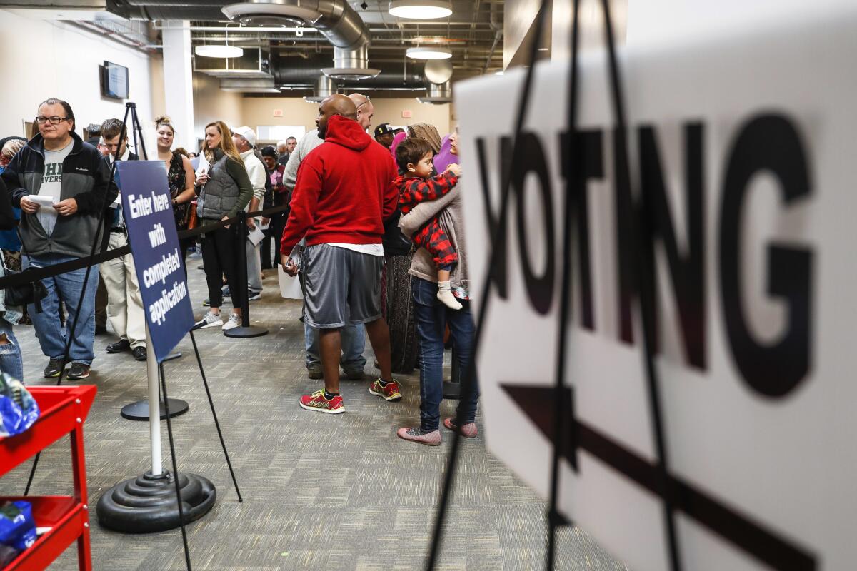 A line of early voters wait in line at the Franklin County Board of Elections on Monday in Columbus, Ohio.