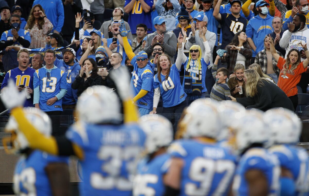 Chargers fans cheer on their team during the second half of Sunday's win over the Broncos at SoFi Stadium.
