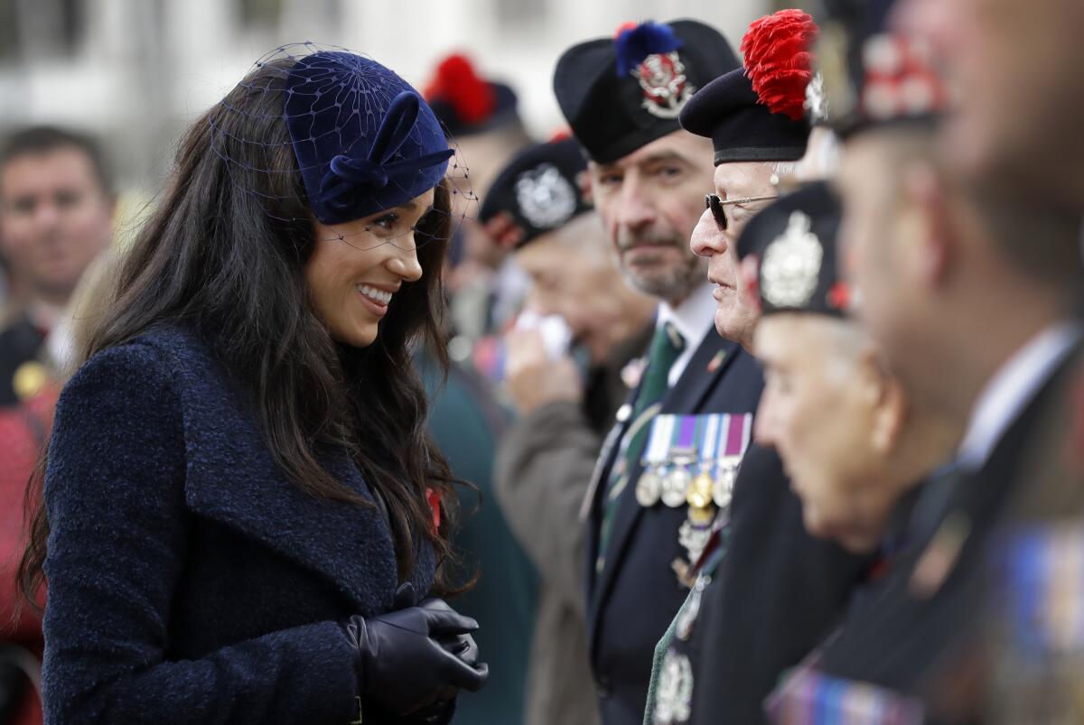 Britain's Meghan, the Duchess of Sussex, meets veterans and soldiers as she attends the 91st Field of Remembrance at Westminster Abbey in London.