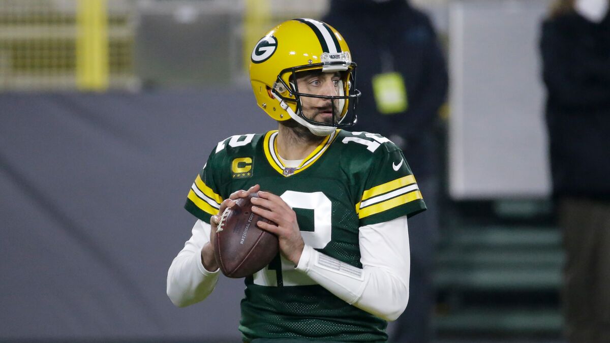 The Green Bay Packers' Aaron Rodgers looks to pass during a game against the Carolina Panthers on Dec. 19, 2020.