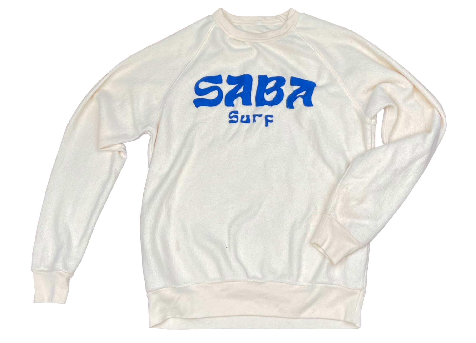 A white Saba Surf crewneck sweater with the company name on the front