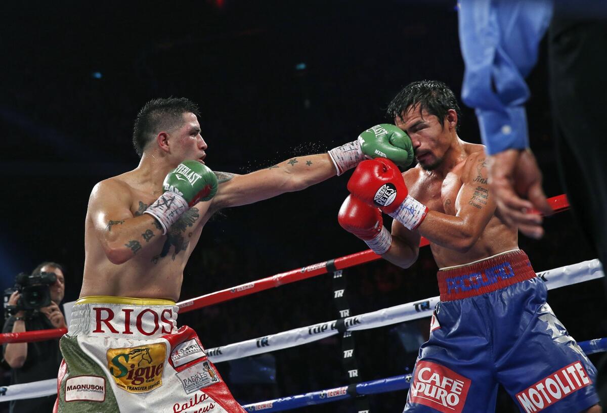 Brandon Rios lands a left jab against Manny Pacquiao during a bout on Nov. 24, 2013. Rios lost that bout, and a 2015 match with Timothy Bradley Jr. that led him to retire for almost two years.