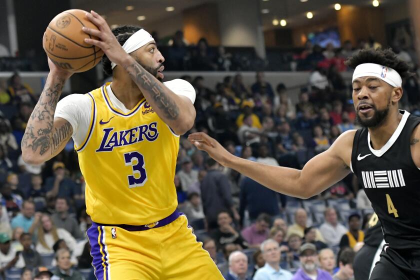 Los Angeles Lakers forward Anthony Davis (3) is defended by Memphis Grizzlies guard Jordan Goodwin.