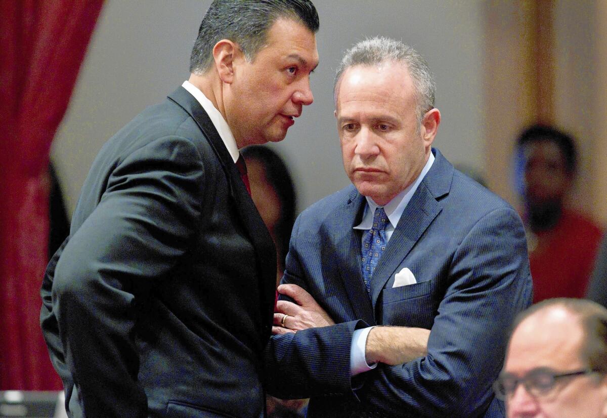 State Senate President Pro Tem Darrell Steinberg (D-Sacramento), right, and Sen. Alex Padilla (D-Pacoima) confer after a bipartisan vote to suspend three Democratic senators. The three -- Ronald Calderon, Leland Yee and Roderick Wright -- will continue to be paid.
