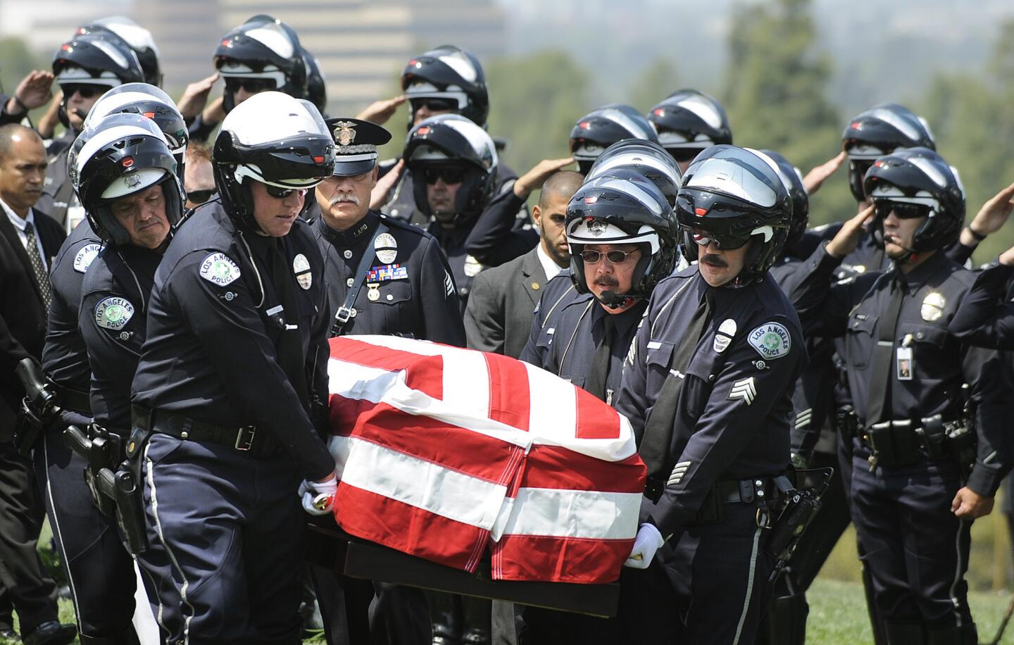 LAPD pallbearers carry the casket of fellow officer Chris Cortijo during burial services at Forest Lawn Hollywood Hills.
