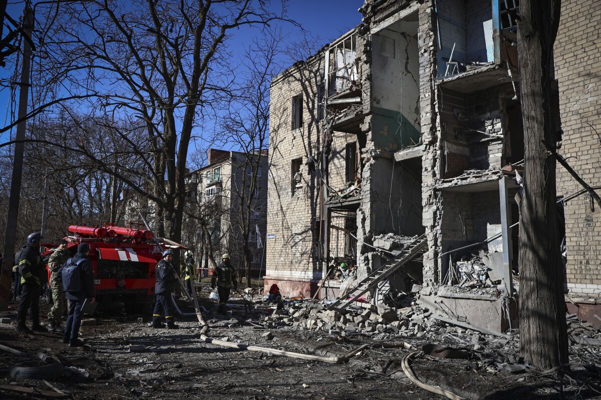 Ukrainian Emergency Service rescuers work on a building damaged by shelling in Kramatorsk, Donetsk region, Ukraine, Tuesday, March 14, 2023. One person has been killed, according to local authorities. (AP Photo/Roman Chop)