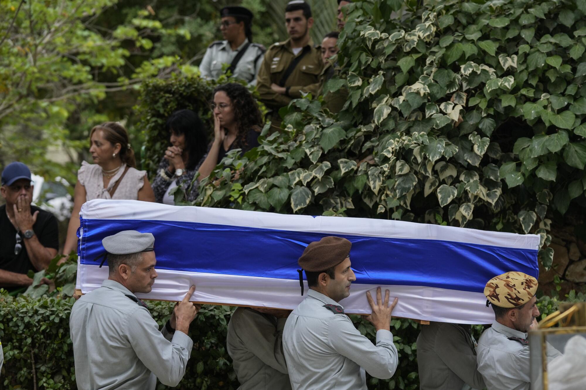 Israeli soldiers carrying flag-covered coffin