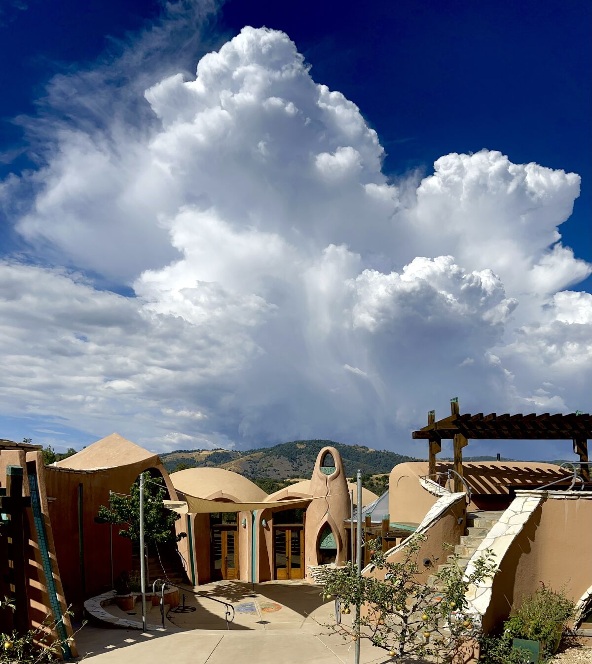 Thunderhead clouds over artist James Hubbell's Ilan-Lael Foundation headquarters in Santa Ysabel.