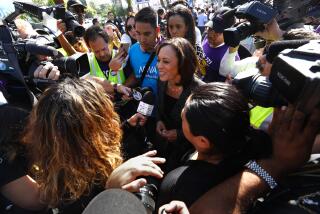 LOS ANGELES, CA - OCTOBER 2, 2019 - - Senator Kamala Harris, center, speaks to media after addressing hundreds of airport workers, Uber and Lyft drivers, janitors, city and county workers, and other workers before marching to Los Angeles International Airport in Los Angeles on October 2, 2019. The marchers are demanding that elected officials, locally, statewide and federally, take action to support unions for all people--no matter where they work. Workers also marched for better pay and benefits and want to unionize. The rally is on behalf of all kinds of workers, from rideshare to fast food to airport service workers. Speakers also included Los Angeles County Supervisor Janice Hahn, former state Sen. Kevin de Leon and Mary Kay Henry, president of the Service Employees International Union. The Rev. Jesse Jackson was also in attendance. (Genaro Molina / Los Angeles Times)