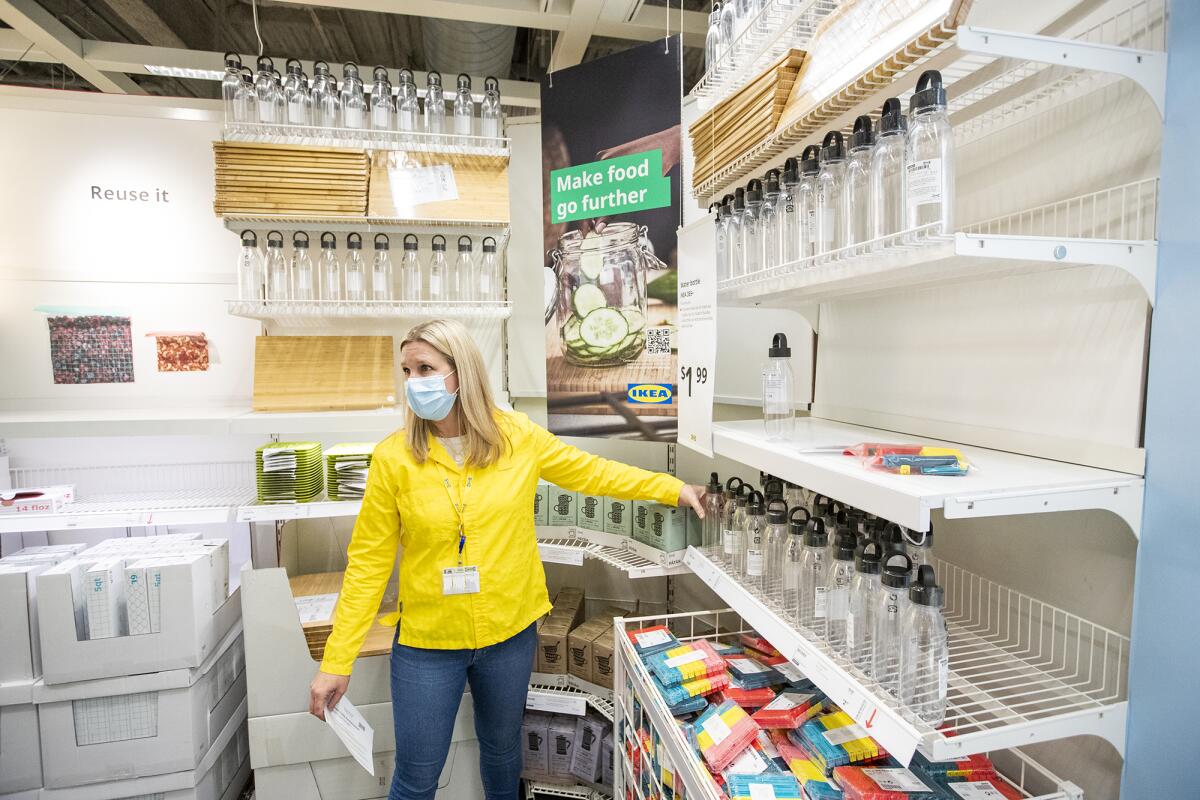 Briana Lehman, market manager for the IKEA in Costa Mesa, gives a tour Thursday of a Sustainable Living Shop at the site.