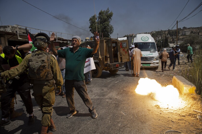 A sound grenade is fired by Israeli forces during a protest against the creation of a new road for Israeli settlers.