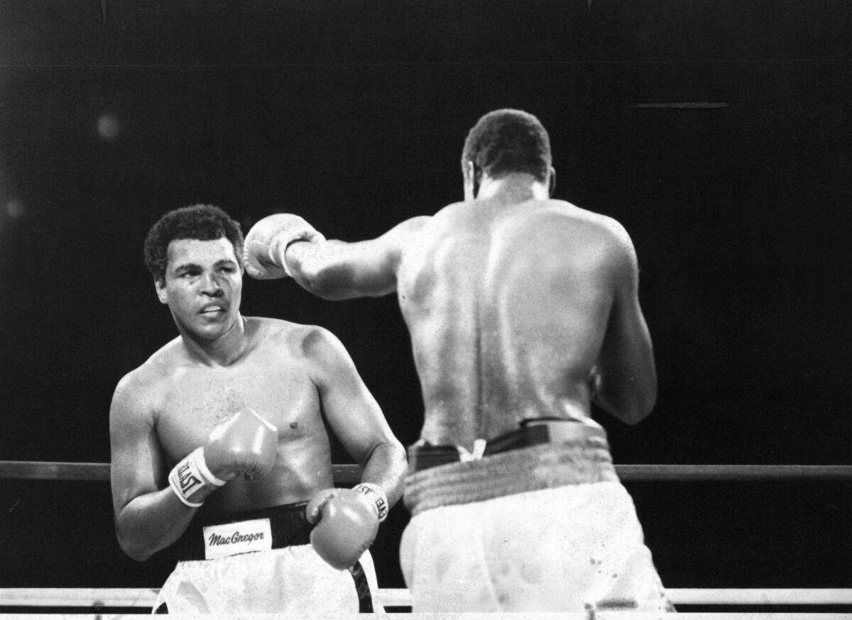 Larry Holmes, right, throws a left jab against Muhammad Ali during the fight at Caesar's Palace on Oct. 2, 1980 in Las Vegas.