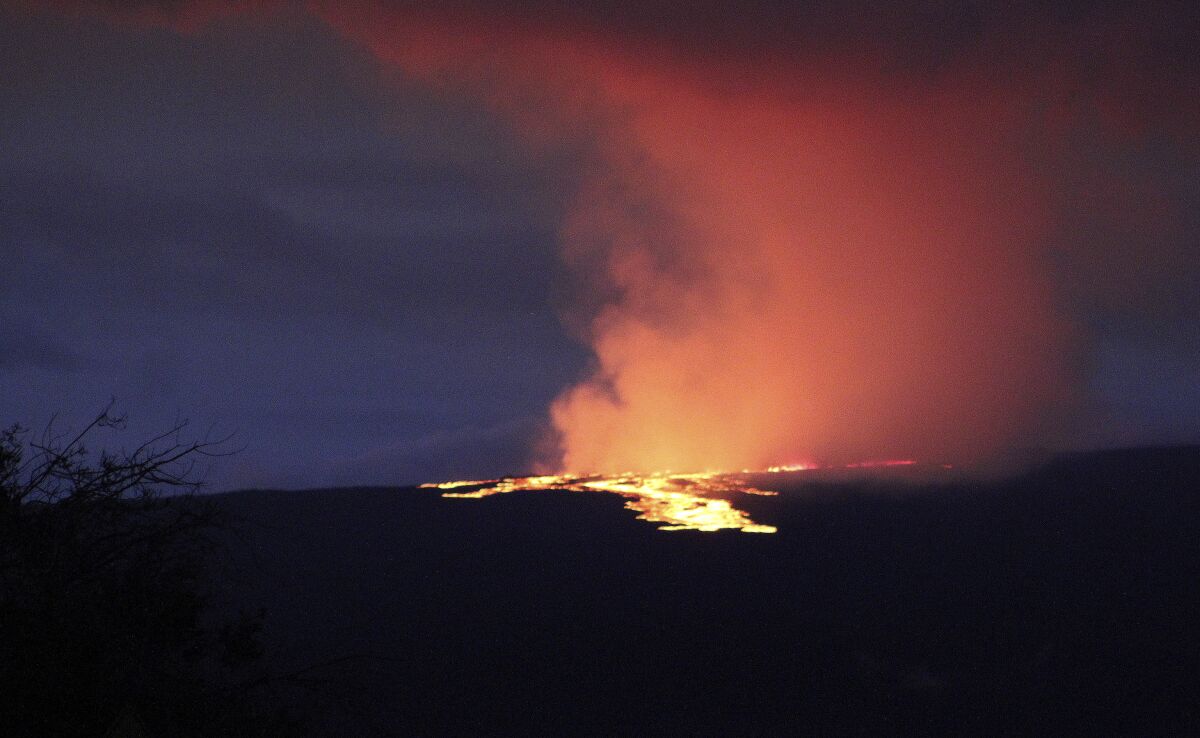 Lava pours out of the summit crater of Mauna Loa
