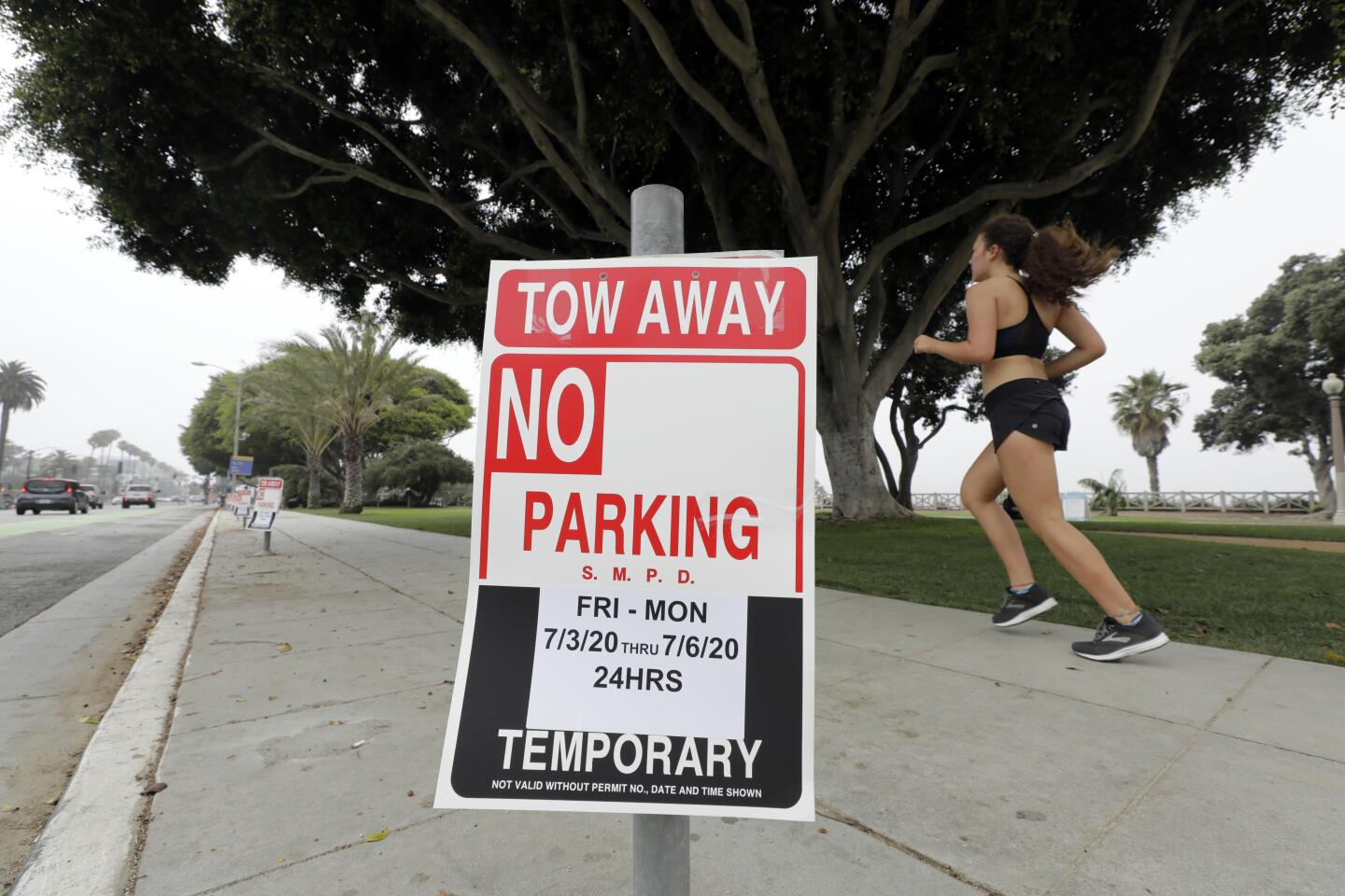 No-parking signs from the July 4 weekend still block spots on Ocean Avenue in Santa Monica on Monday.