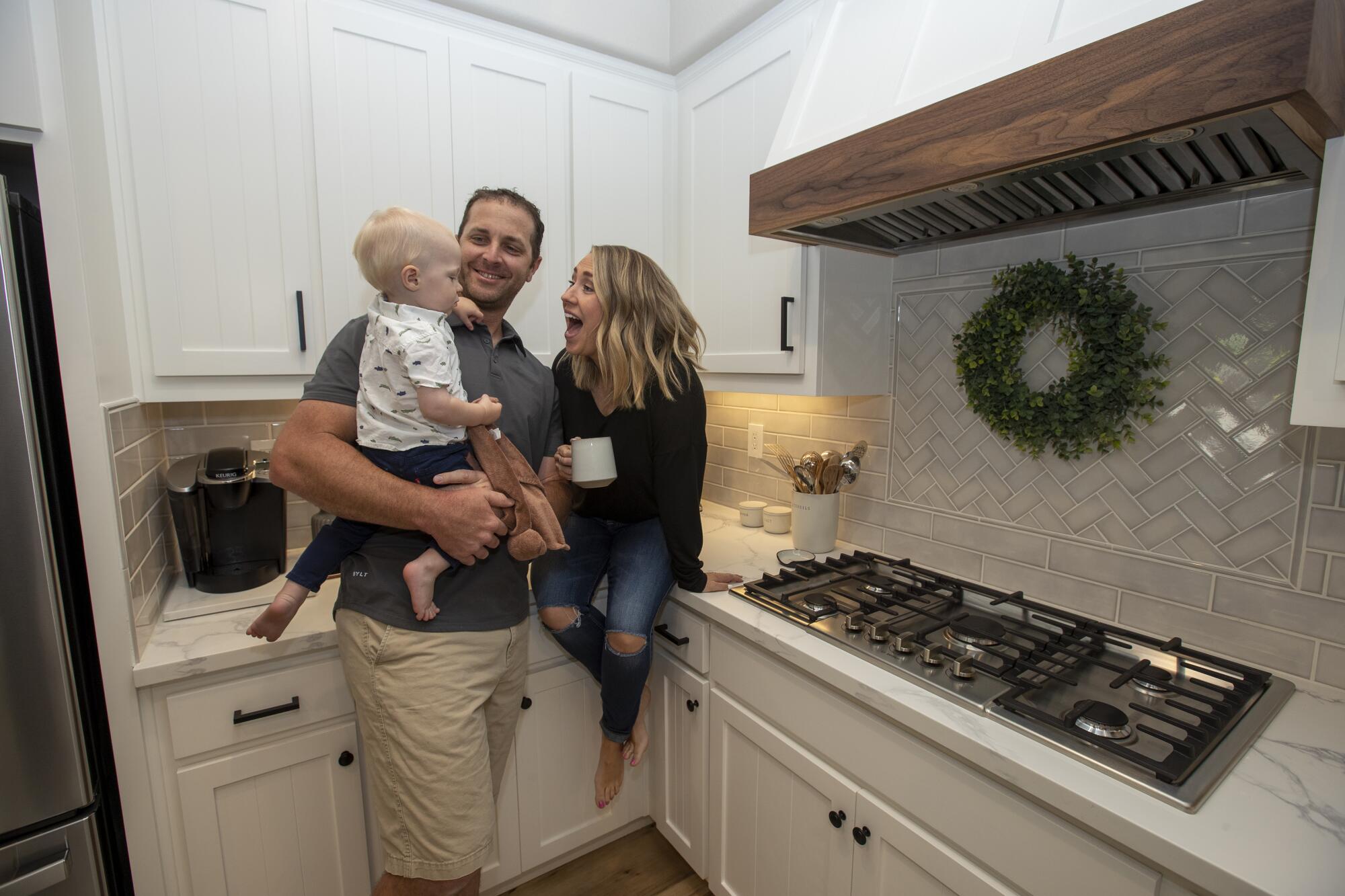 Brian and Rebecca Luke their with son Bennett, 1, in the kitchen of their new home in El Dorado Hills, Calif.