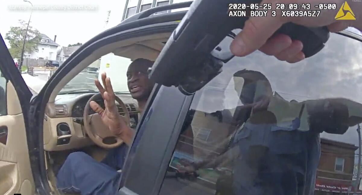 Minneapolis Police Officer Thomas Lane points his gun at George Floyd in body camera video.