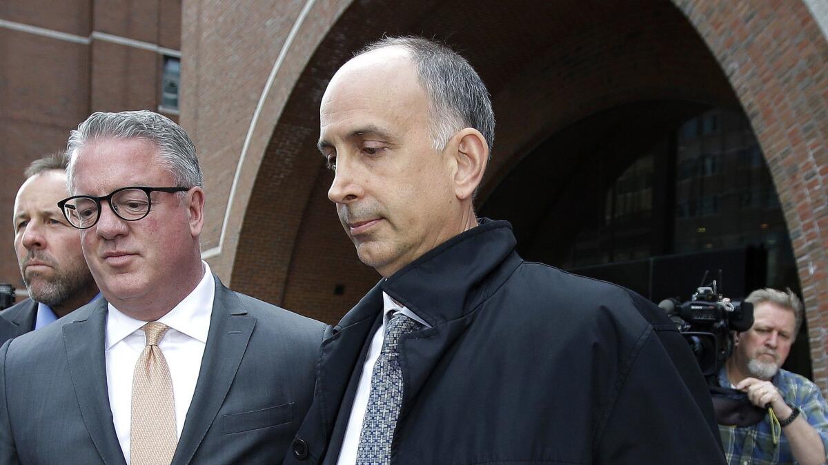 California businessman Stephen Semprevivo departs federal court May 7 in Boston after pleading guilty to charges that he bribed the Georgetown tennis coach to get his son admitted to the school.