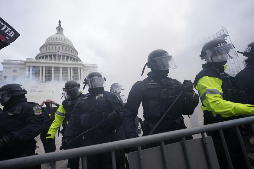 FILE - In this Jan. 6, 2021, file photo, police stand guard after holding off violent rioters who tried to break through a police barrier at the Capitol in Washington. New details from the deadly riot of Jan. 6 are contained in a previously undisclosed document prepared by the Pentagon for internal use that was obtained by the Associated Press and vetted by current and former government officials. (AP Photo/Julio Cortez, File)