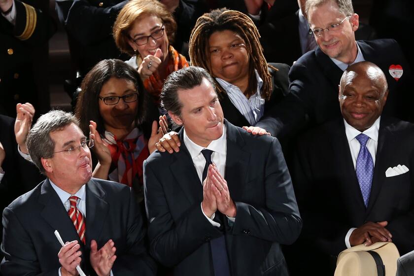 California Lt. Gov. Gavin Newsom looks on during a rally after hearing results from the U.S. Supreme Court's rulings on gay marriage at San Francisco City Hall.