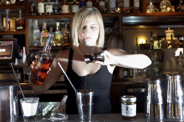 Tricia Alley, head bartender at the Studio City restaurant Black Market Liquor Bar, works on making a Thyme Fix, with Angostura bitters, lemon marmalade, thyme and Fighting Cock bourbon.