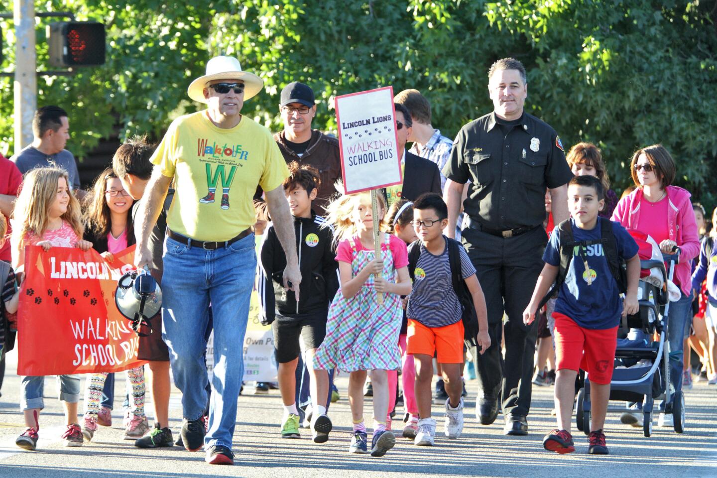 Glendale Fire Dept. chief Greg Fish, right, walked from Crescenta Valley Park with children on Walk-To-School-Day to Lincoln Elementary School in La Crescenta on Wednesday, October 7, 2015.