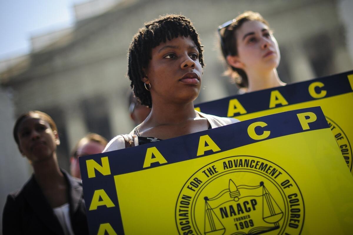 Jessica Pickens, 19, of Chicago, Ill., stands with fellow voting rights activists outside the Supreme Court in Washington, D.C., the day the court ruled on the Voting Rights Act, striking down portions of the law.
