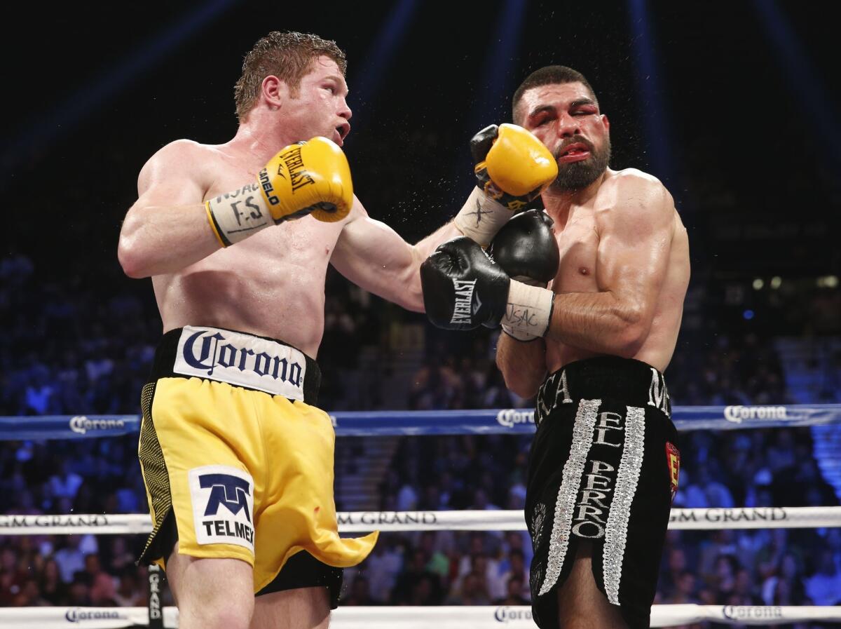 Saul "Canelo" Alvarez lands a punch against Alfredo Angulo during a main event in Las Vegas on March 8, 2014.