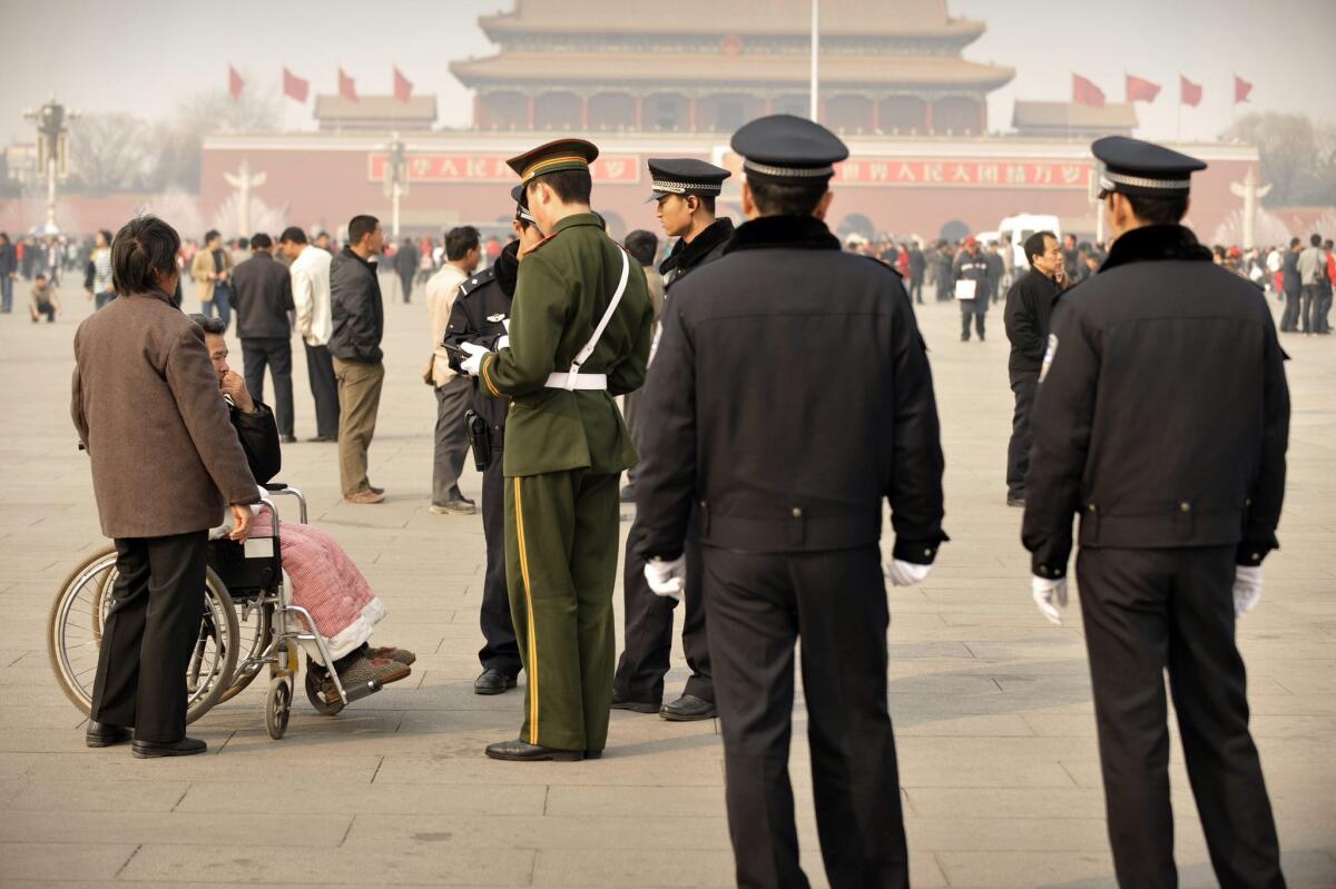 In this 2008 file photo, Chinese police stop and search a man in Tiananmen Square. Police brutality -- and impunity -- is a major issue in China, where the Communist party exercises absolute control over not only the police, but also the courts and media.