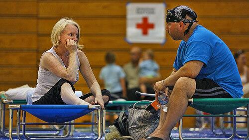 La Ca?ada Flintridge residents Sue Miles, left, and her husband John, try to relax at a temporary shelter in the La Ca?ada High School gym after receiving a mandatory evacuation order to leave their house Saturday afternoon.
