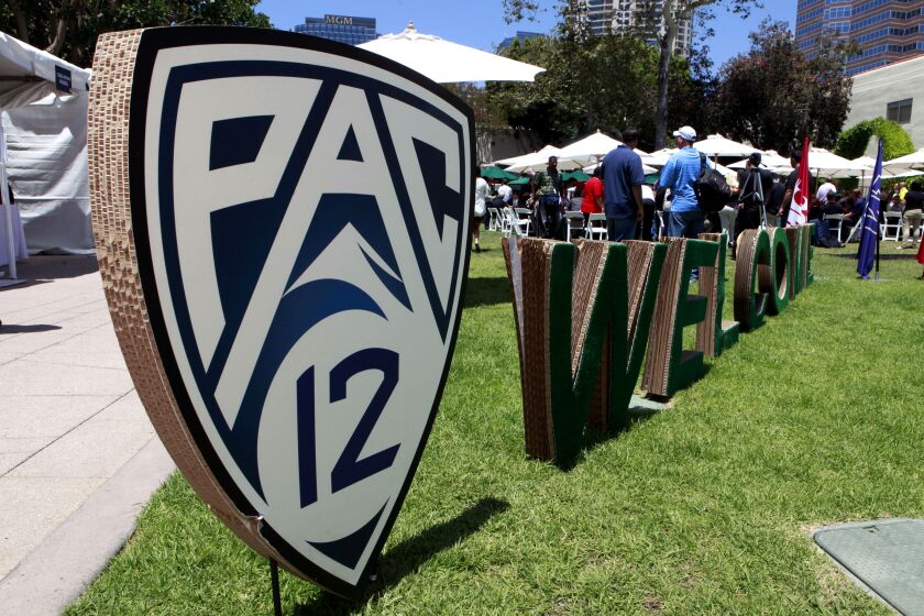 Guests are welcomed to the Pac-12 football media day outside the commissary at Fox Studios in Los Angeles.