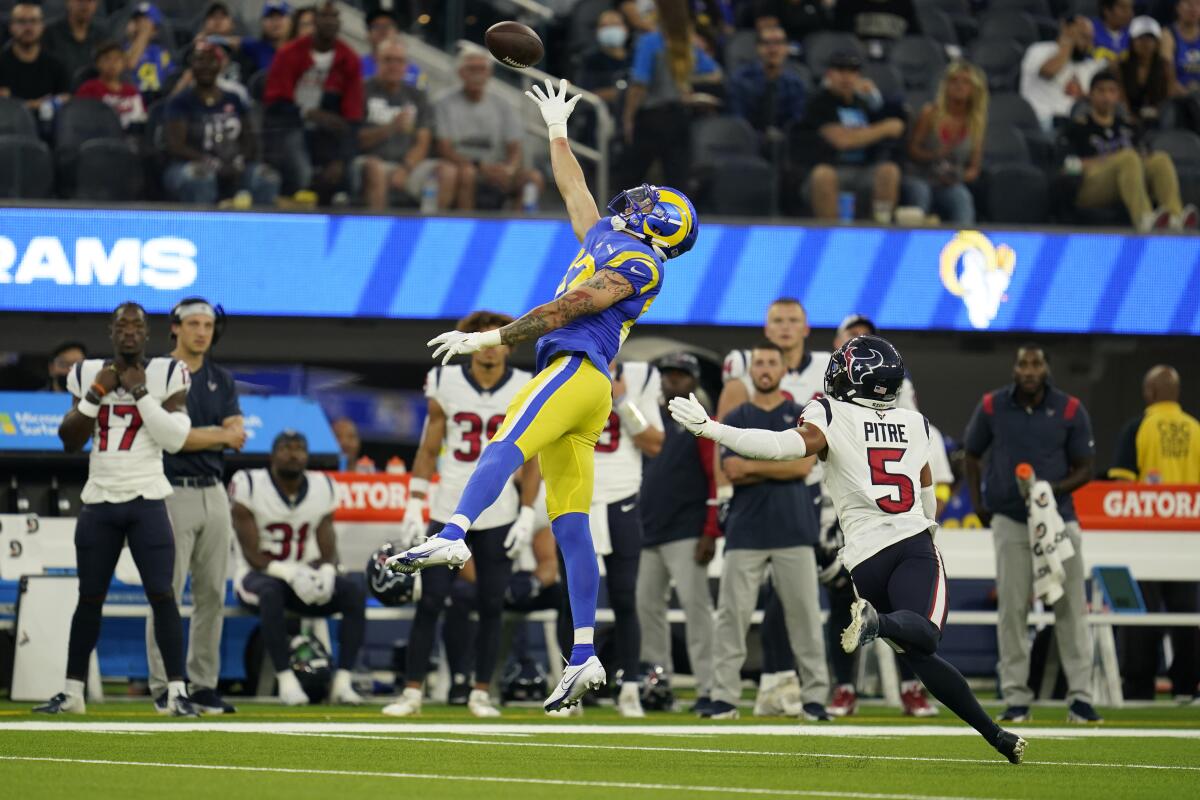 Jacob Harris jumps for the ball as the Rams play the Texans.