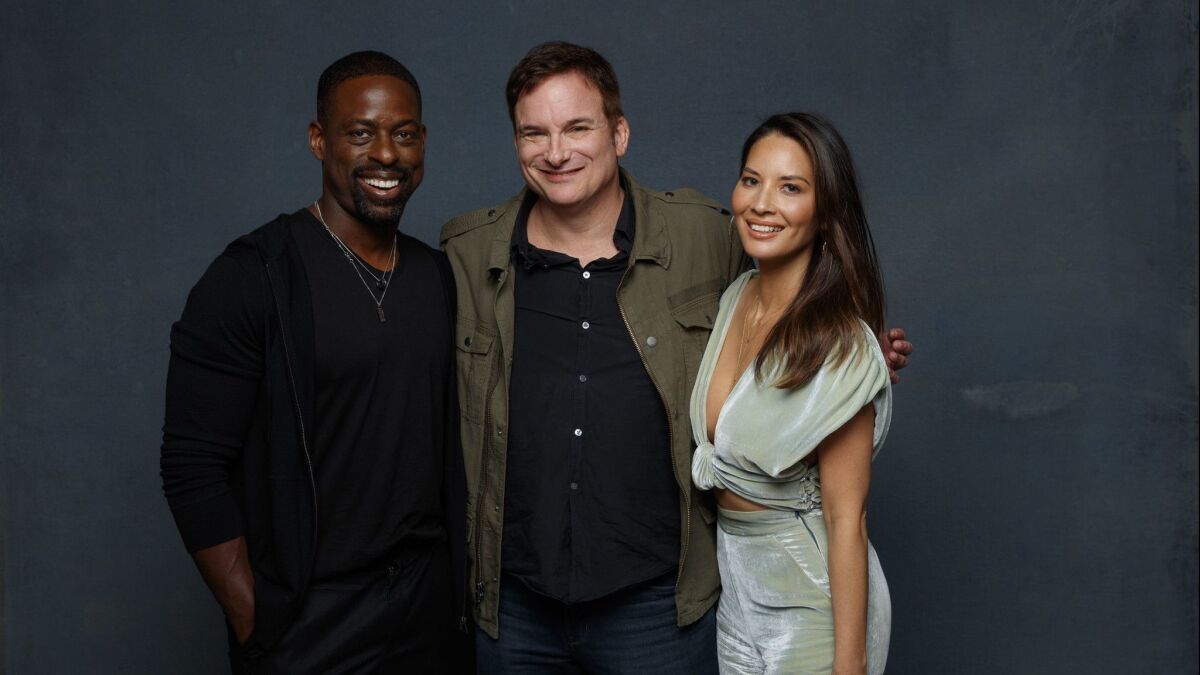 Shane Black and Olivia Munn, pictured here with fellow "Predator" star Sterling K. Brown, at the L.A. Times Photo and Video Studio at Comic-Con 2018, in July.
