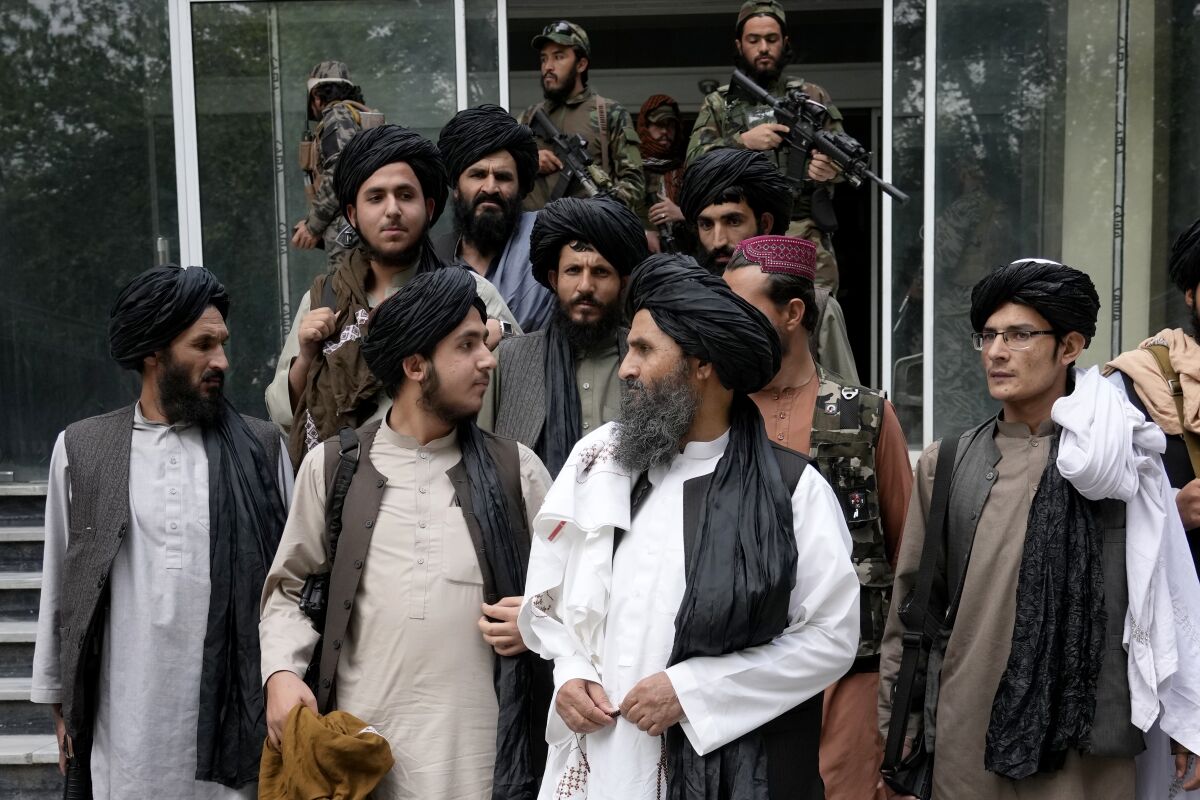 FILE - Mullah Abdul Ghani Baradar, acting deputy prime minister of the Afghan Taliban's caretaker government, center, and other Taliban officials attend a ceremony marking the 9th anniversary of the death of Mullah Mohammad Omar, the late leader and founder of the Taliban, in Kabul, Afghanistan, April 24, 2022. The Pakistani Taliban said Wednesday May 18, 2022, that they are extending a cease-fire with the government in Islamabad until May 30, after the two sides held an initial round of talks in neighboring Afghanistan. The militant group, known as Tehrik-e-Taliban Pakistan or TTP, said in a statement on Wednesday that the talks were facilitated by Afghanistan’s new Taliban rulers. (AP Photo/Ebrahim Noroozi, File)
