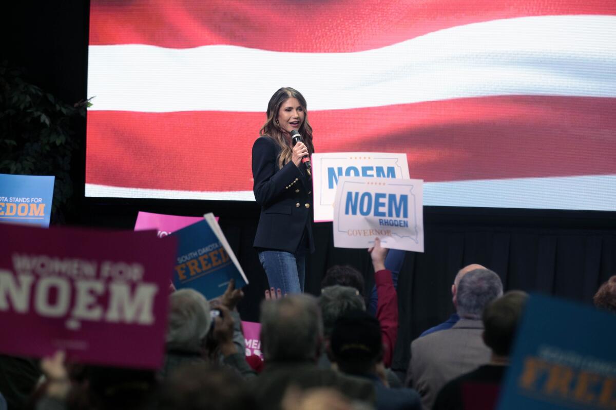 South Dakota Gov. Kristi Noem takes the stage at a campaign rally Wednesday, Nov. 2, 2022 in Sioux Falls, S.D. The Republican governor was looking to shore up support for her reelection bid with a series of events with Virginia Gov. Glenn Youngkin and Rep. Tulsi Gabbard. (AP Photo/Stephen Groves)