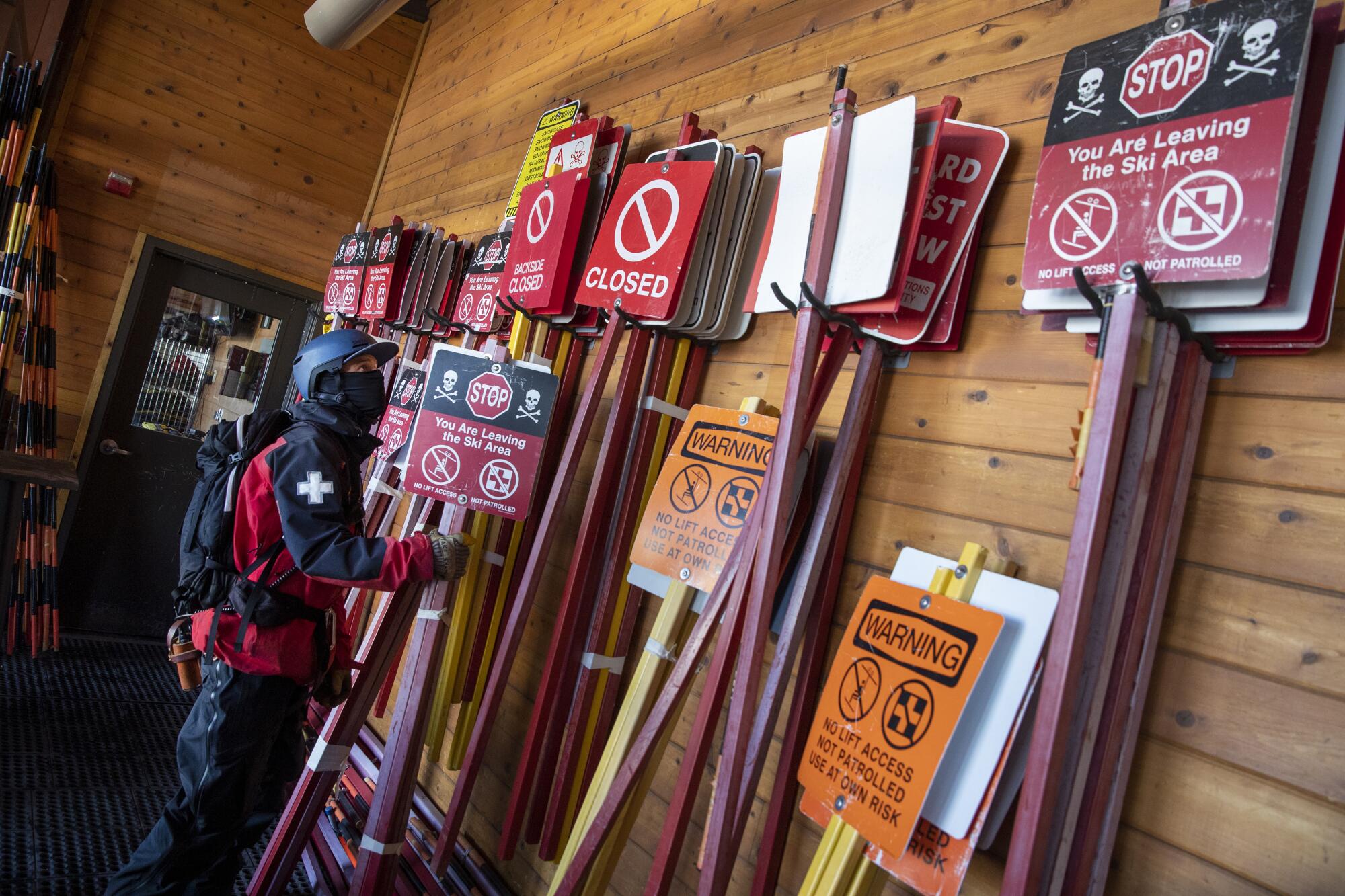 Ski patrolman Dan Friedman prepares to set out warning signs 