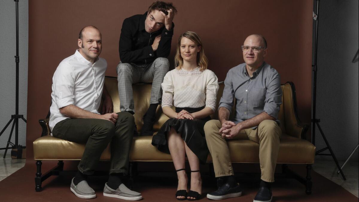 Brothers Nathan Zellner, left, and David Zellner, right, pose at the London West Hollywood Hotel on June 13 with the stars of their movie "Damsel," Robert Pattinson, second from left, and Mia Wasikowska.