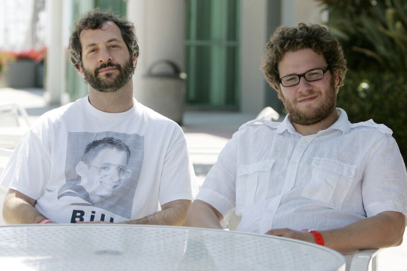In an interview with the L.A. Times, Judd Apatow, left, criticized theater chains for pulling "The Interview," which stars Seth Rogen, right.