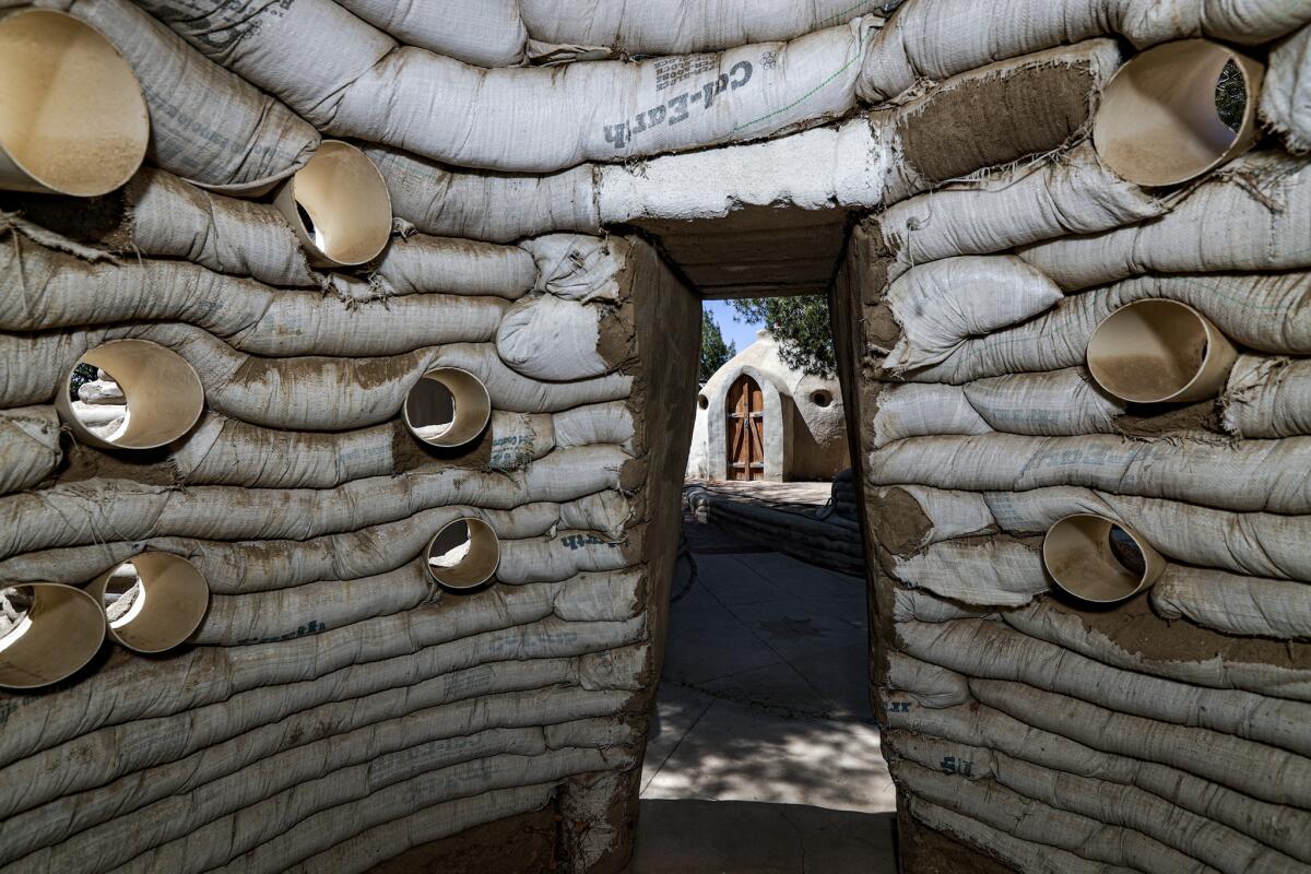 The range of CalEarth structures runs from fully staged houses to rudimentary, domed emergency shelters constructed of stacked earth.