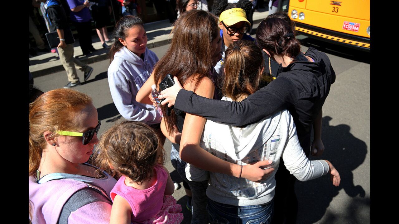 Friends and family are reunited with students at the local fairgrounds after a mass shooting at Umpqua Community College in Roseburg, Ore., on Thursday.
