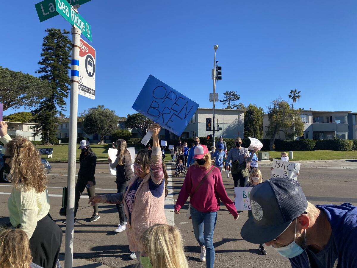 Parents and students from the La Jolla Cluster schools protest ongoing school closures Feb. 18 near Bird Rock Elementary.