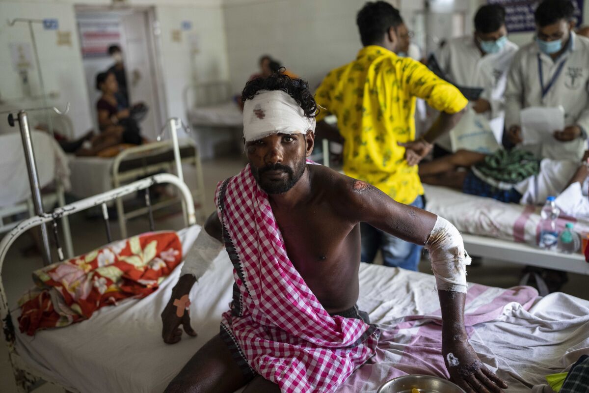 A passenger who was injured in Friday's train accident receives treatment at a hospital in Balasore district, in the eastern state of Orissa, India, Sunday, June 4, 2023. The derailment in eastern India that killed 275 people and injured hundreds was caused by an error in the electronic signaling system that led a train to wrongly change tracks and crash into a freight train, officials said Sunday. (AP Photo/Rafiq Maqbool)