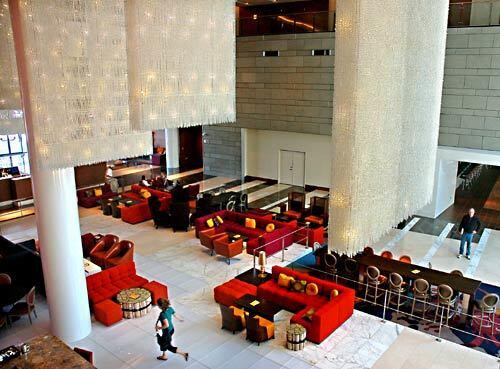 Shiny stone and concrete floors and a colorful array of couches and armchairs greet the visitor to the lobby of the JW Marriott, whose rooms are on floors 4-21 of a 54-story building near the 110 Freeway.