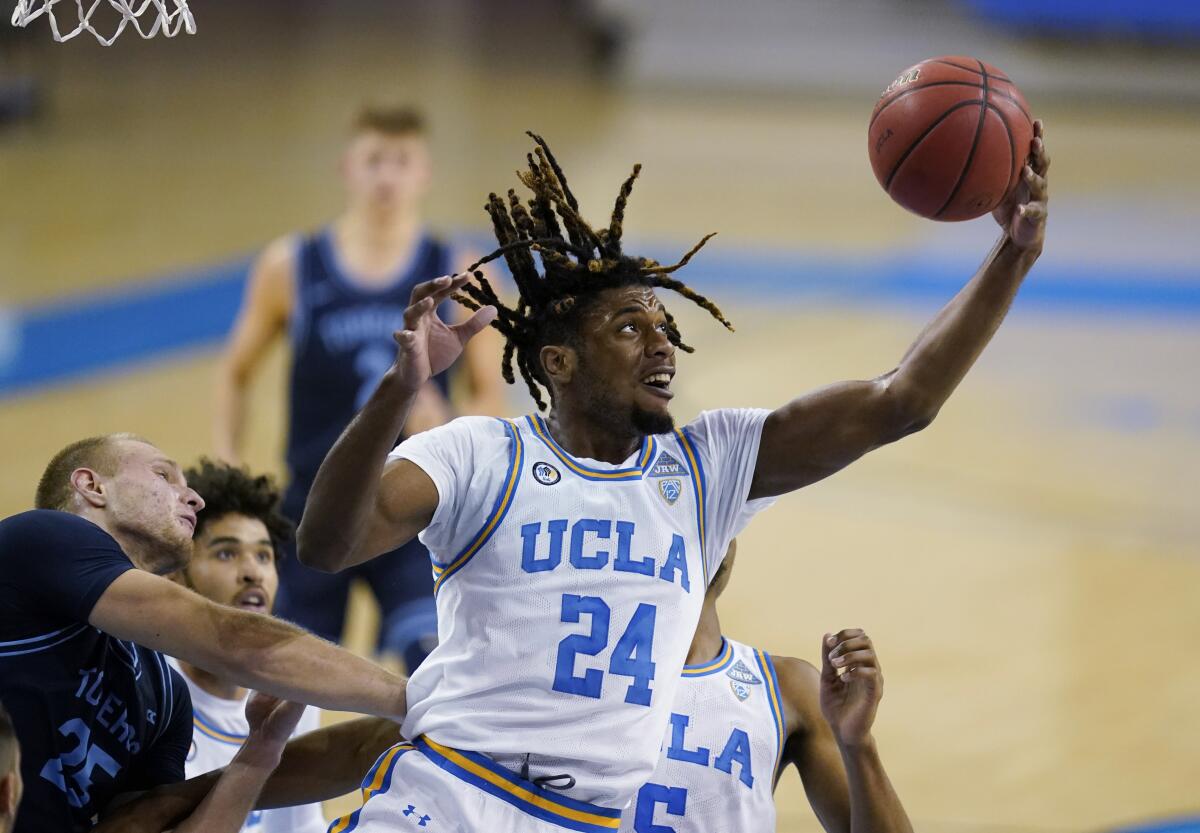 UCLA forward Jalen Hill grabs a rebound during a game against San Diego in December 2020.