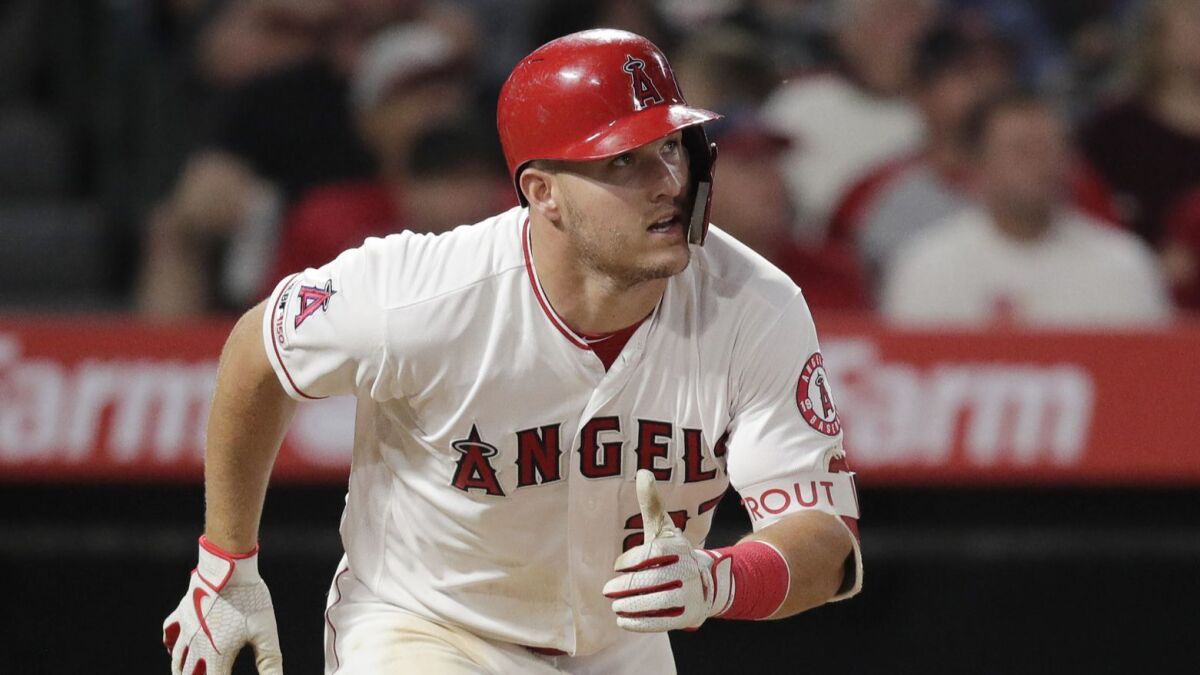 Angels center fielder Mike Trout runs toward first base after a hit against the Milwaukee Brewers on April 8.